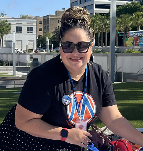Yasmina White wearing a MomsRising shirt