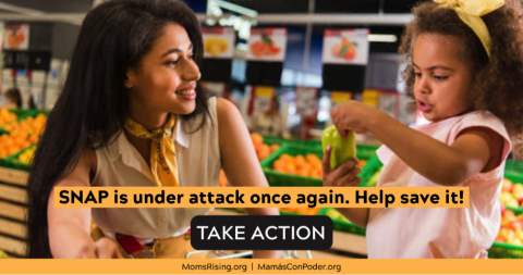 [IMAGE DESCRIPTION: A photo of a person with long black hair smiling at a child. They're in a grocery store.]