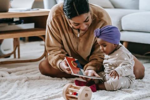 Black mom reading to baby