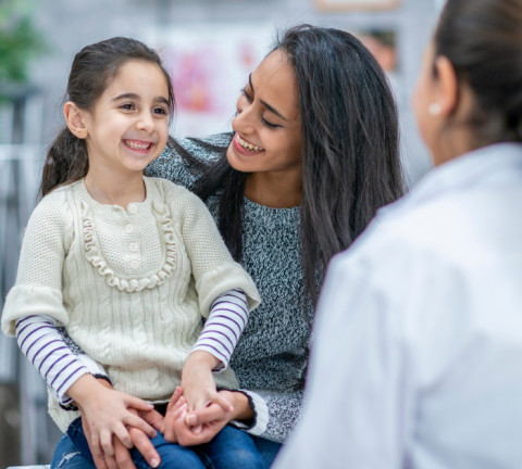 Mom and daughter talk with a doctor