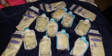Pumping and expressing breastmilk is vital to sustaining breastfeeding when parent and baby are separated. Photo courtesy of Shannon O'Hara Photography 13 bags of expressed breastmilk on a black background. Photo courtesy of Shannon O'Hara Photography