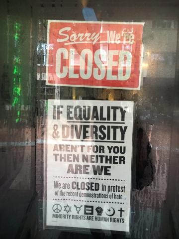 A sign on a business in downtown Charlottesville, Virginia.