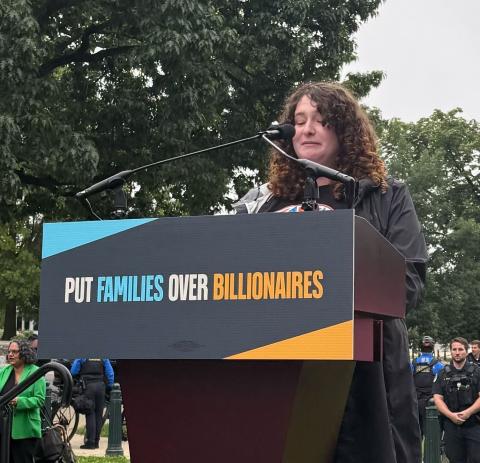 Arielle speaking at a podium in front of the Capitol