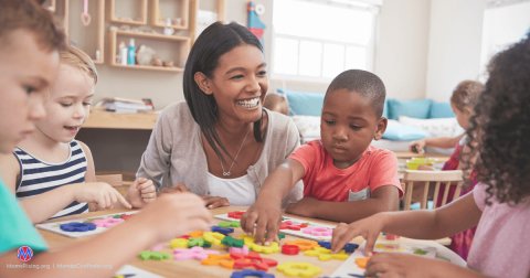 Child care teacher and children learning and playing together.