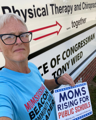 Beacon Hub Leader Anna Knapp dropped off a MomsRising storybook at Rep Tony Wied’s office (WI-08).