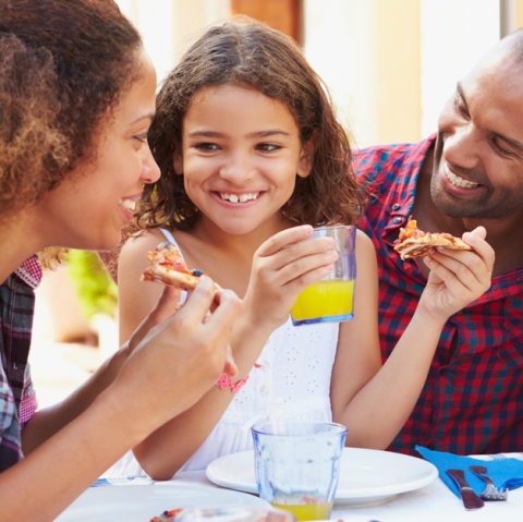 Happy family eating a meal