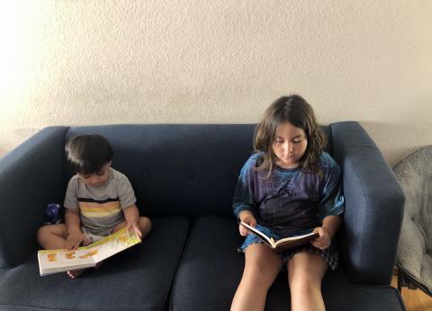 Melody and Maximo Perez spending time together reading books that promote bilingualism and inclusion.