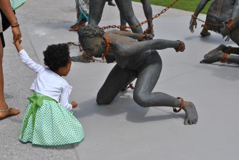 Lian Noel-Howard holds the hand of her mother, Jaleesa Capri