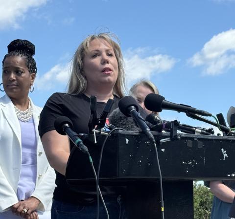 Meghan speaking at a podium