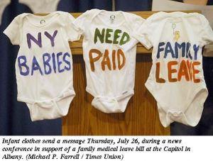 Baby shirts with hand painted messages to support paid family leave in New York.