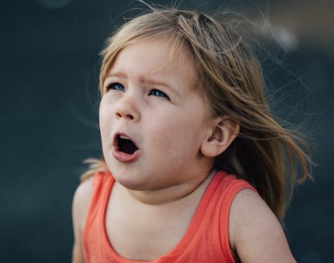 A scared toddler looking up. Photo by Patrick Fore on UnSplash.
