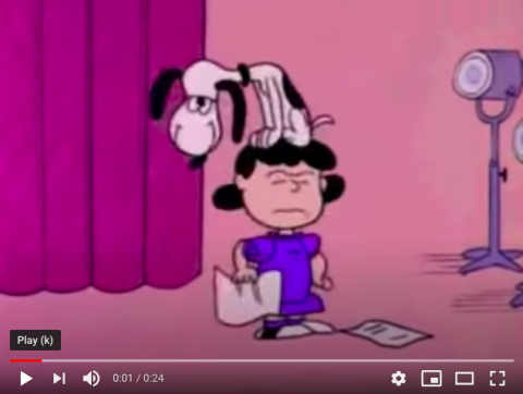 [IMAGE DESCRIPTION: A screenshot of Snoopy the beagle sitting on Lucy's head, from A Charlie Brown Christmas]