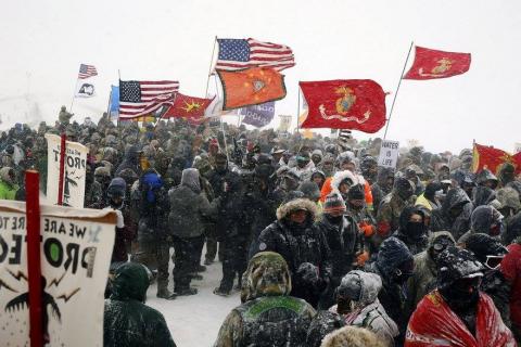 [IMAGE DESCRIPTION: A group of veterans joins the water protectors at Standing Rock.]