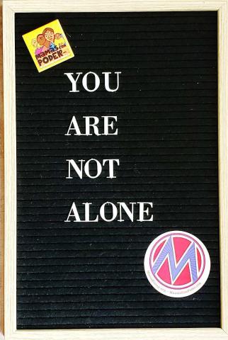 [IMAGE DESCRIPTION: A photo of a letterboard with the words "You are not alone" on it.]
