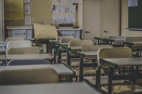 {image description: empty school classroom chairs}