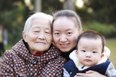 [IMAGE DESCRIPTION: A photo of a family of three people smiling at the camera.]