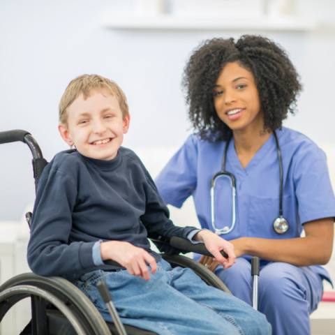 boy in wheelchair with nurse