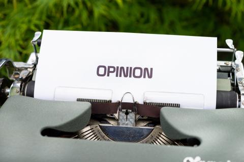 photo of a page on a typewriter with the word opinion