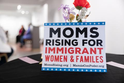 PHOTO of MomsRising for Immigrant Women and Families poster at San Antonio Event