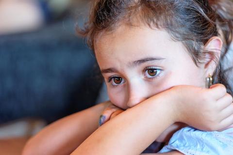 [IMAGE DESCRIPTION: A photo of a young child looking off to the side, a worried look on their face.]