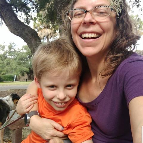 Smiling boy and mom with her arm around him