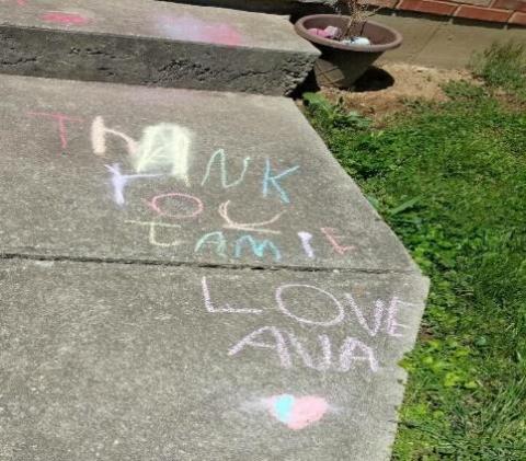 [IMAGE DESCRIPTION: A photo of a sidewalk with a thank you message written in chalk]