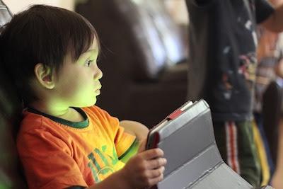 child looking at tablet