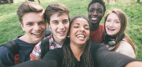 A group selfie of white and Black teenagers