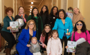 MomsRising members and staff with Rep. Pramila Jayapal at Mombassador storybook delivery event