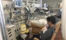 Father holding premature son in hospital.