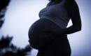 Pregnant woman holding her belly. 