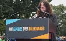 Arielle speaking at a podium in front of the Capitol