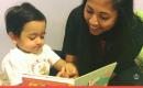A mother and her young son smiling together during an Early Intervention session. 