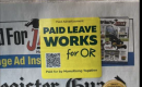 Newspaper with yellow sticker that reads "Paid Leave Works for Oregon" flowers in the background.