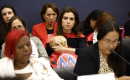 MomsRising member Nathalie holding her baby during MomsRising/DWC/Mamás Caucus "Moms Pay the Price" 