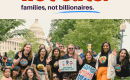 Moms stand in front of the Capitol holding signs in support of health care