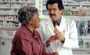 Pharmacist is showing medication to an older woman. 