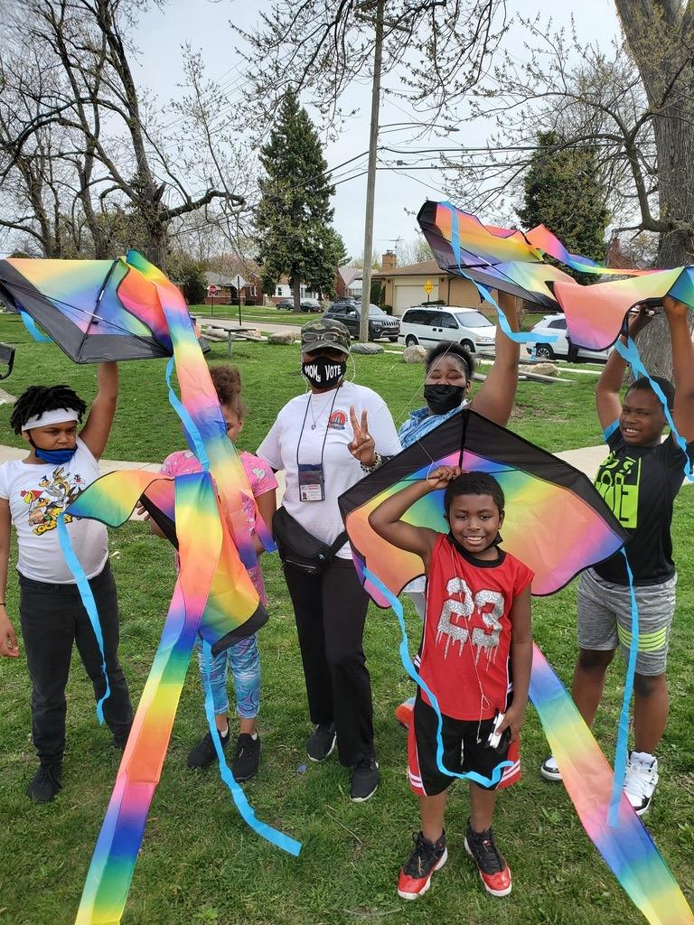 Photo of moms and children in Detroit with their care can't wait kite messages 