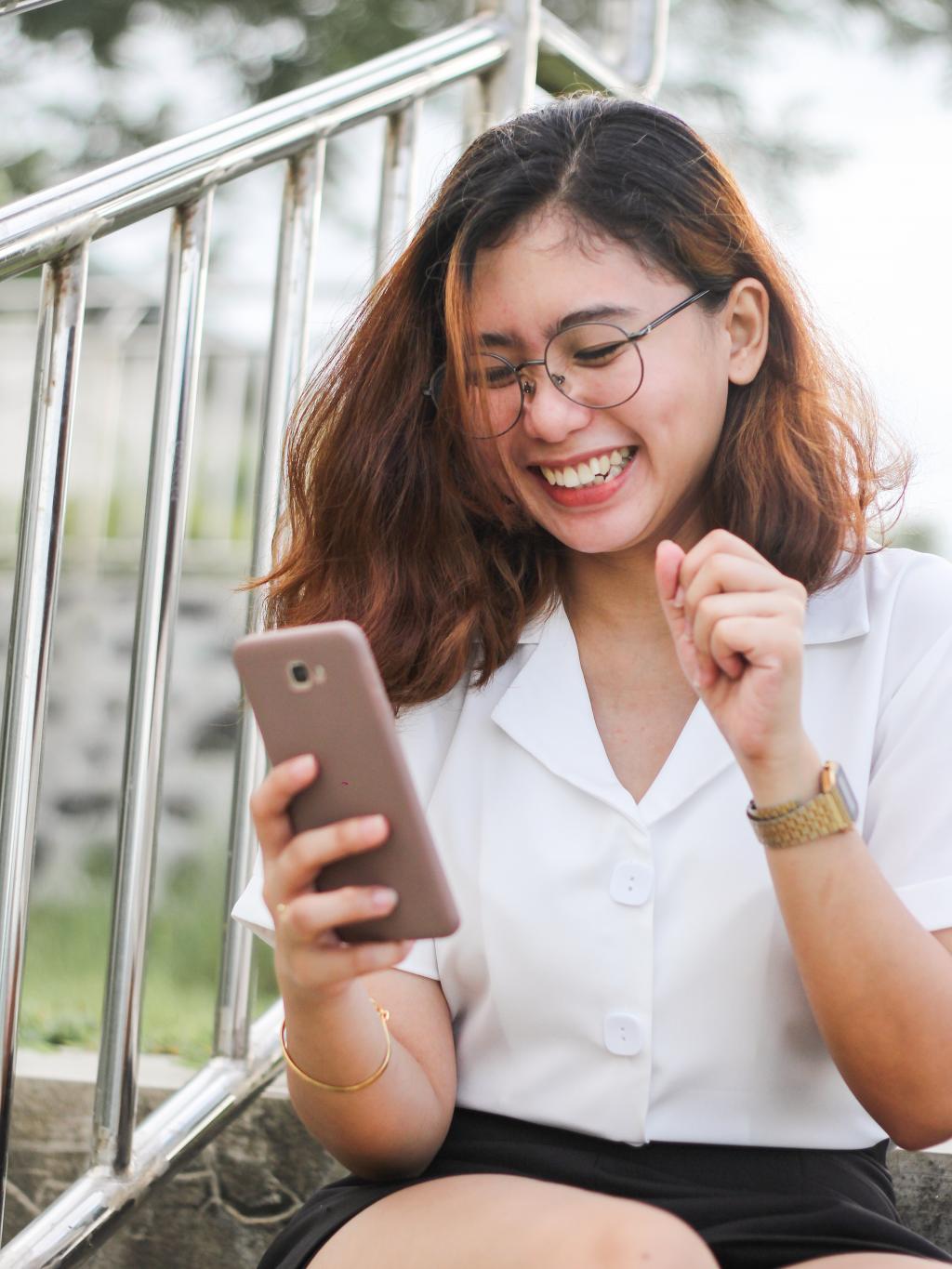 Photo of woman looking at her mobile phone. 