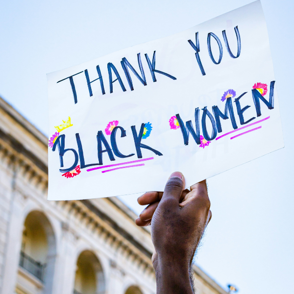 black woman holding up sign thanking Black women
