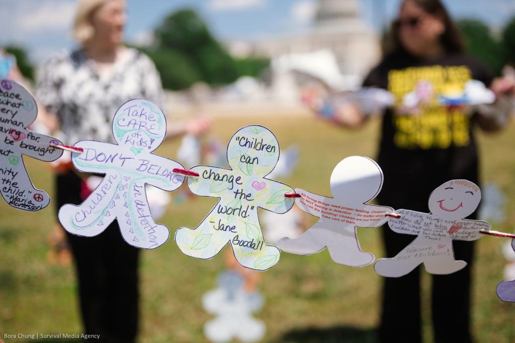 Children shaped paper art with phrases like "'Children can change the world." — Jane Goodall'"