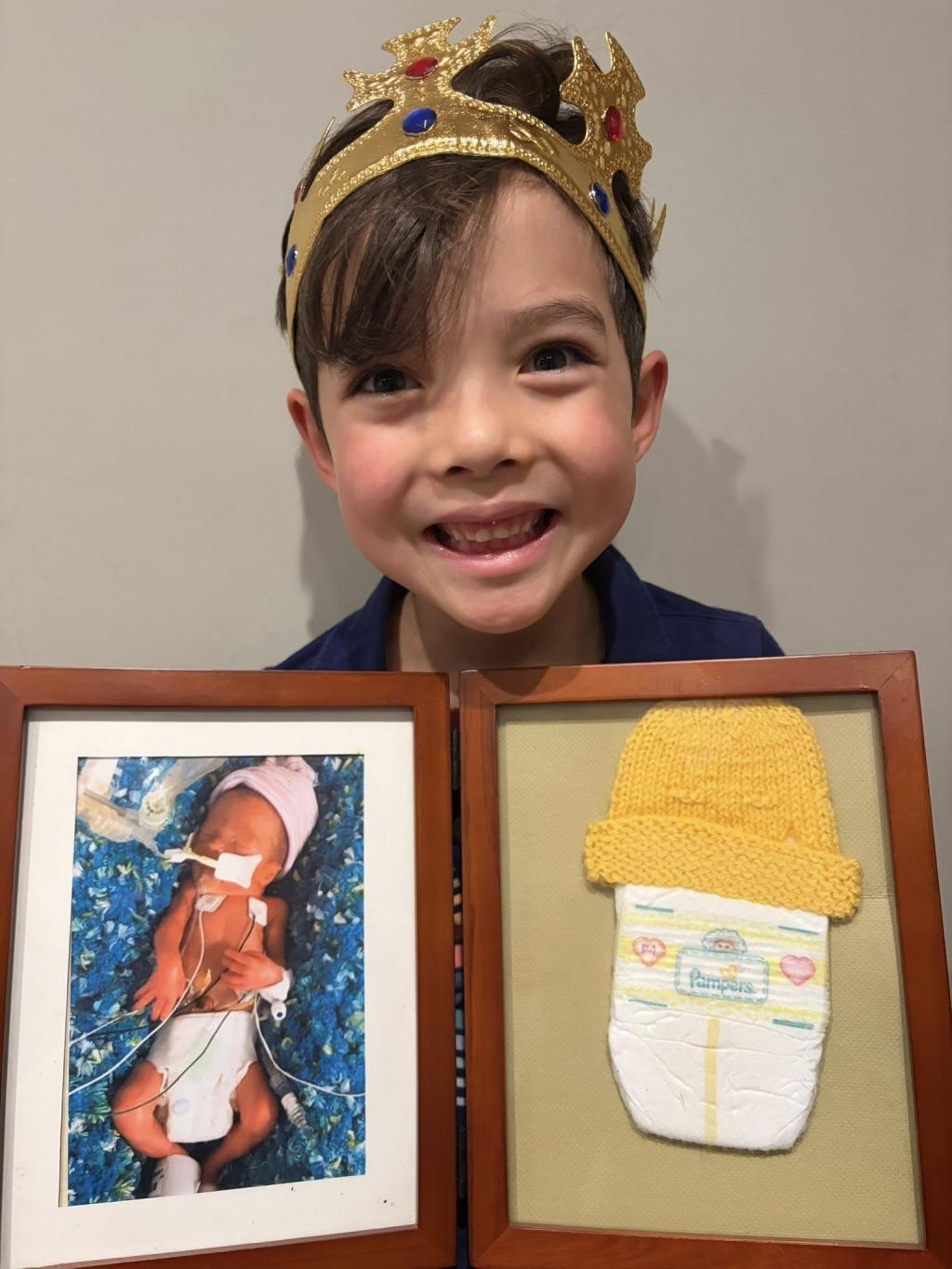 Jean's child holding photo of himself as a baby