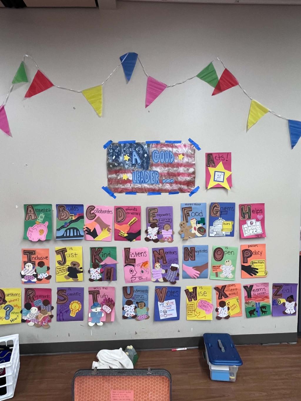 Wall of posters for ABCs of Democracy at Kids Caucus event