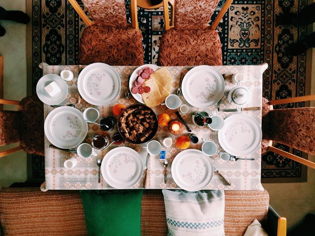 [IMAGE DESCRIPTION: A photograph of a dining table, taken from an overhead view to show the plates and food arranged from above.]