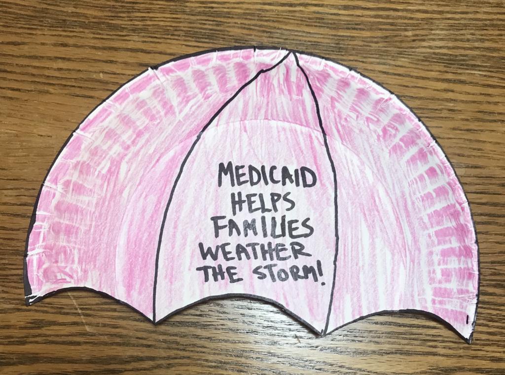 red umbrella craft with "Medicaid Helps Families Weather the Storm"