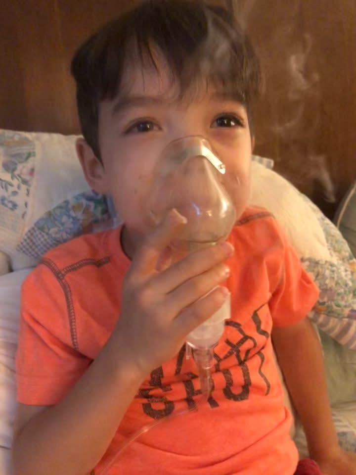My son, getting at home nebulizing treatment.