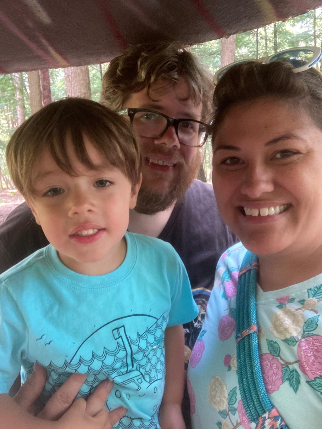 photo of MomsRising member Julie from Michigan with her son and husband