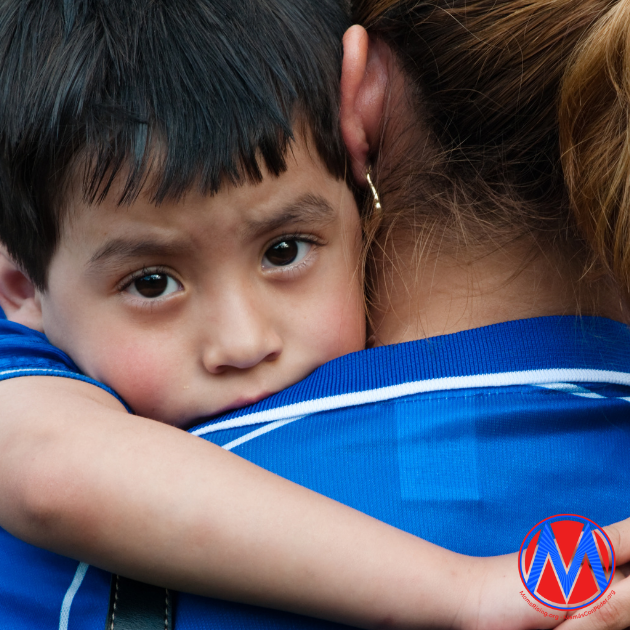 image of young child hugging an adult 