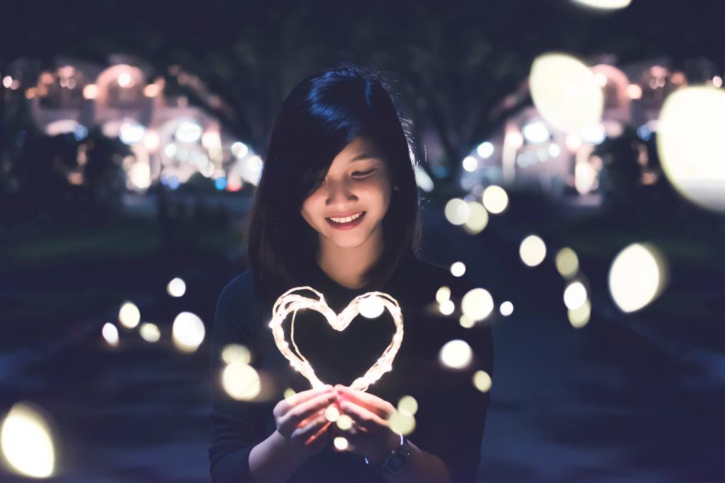 stock photo of a woman holding a sparkling heart