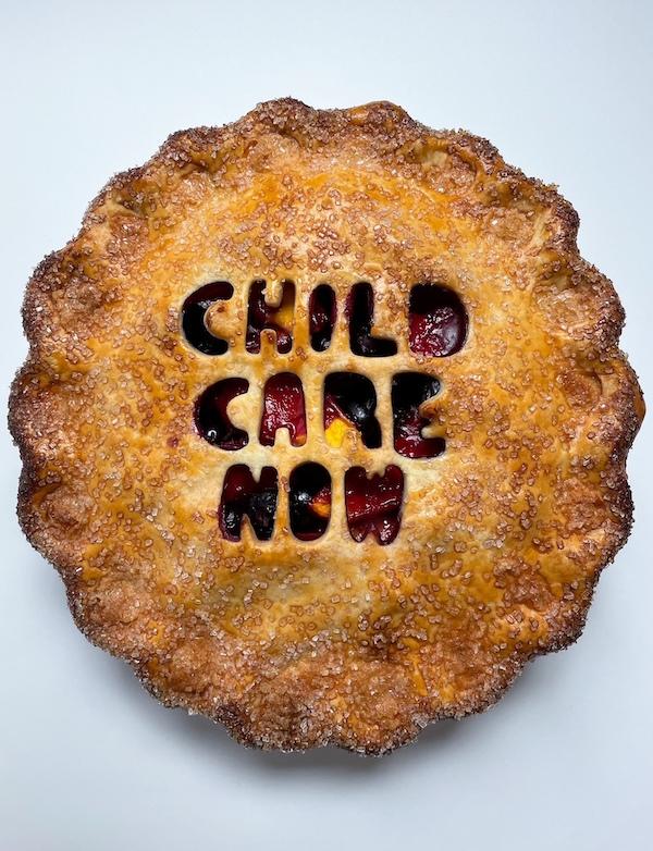Baked pie with the words Child Care Now carved into the top crust